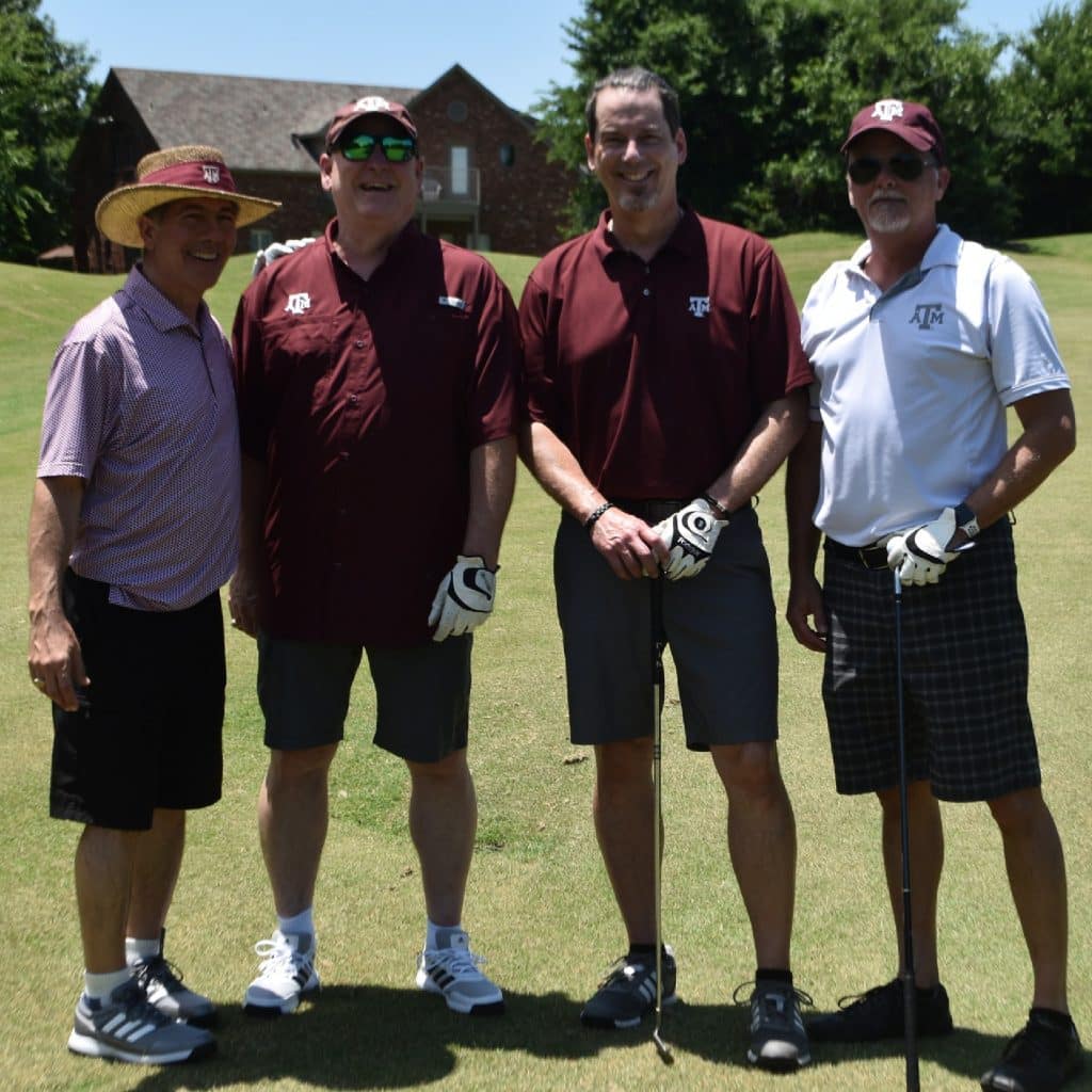 4 male adults posing for picture ready to play golf